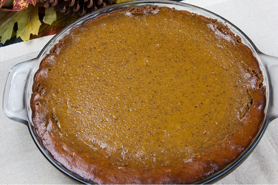 baked gingersnap crust pumpkin pie in a glass pie pan
