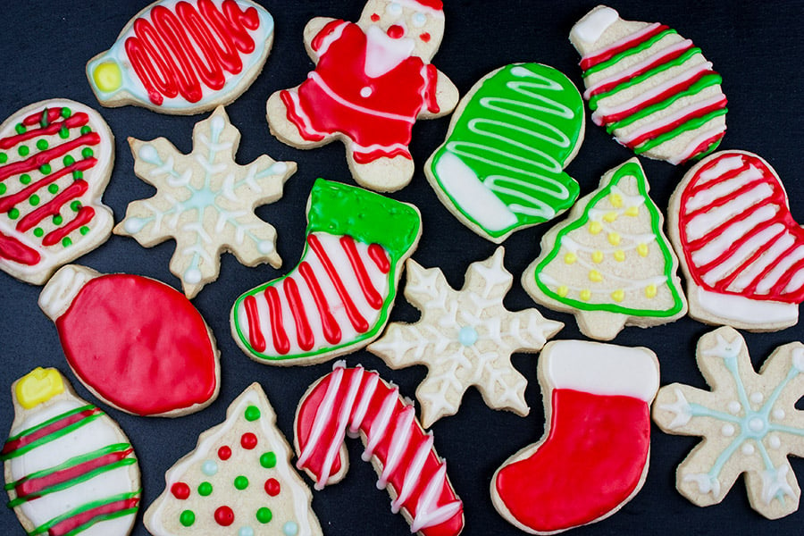 Decorated cut-out sugar cookies on a dark surface.