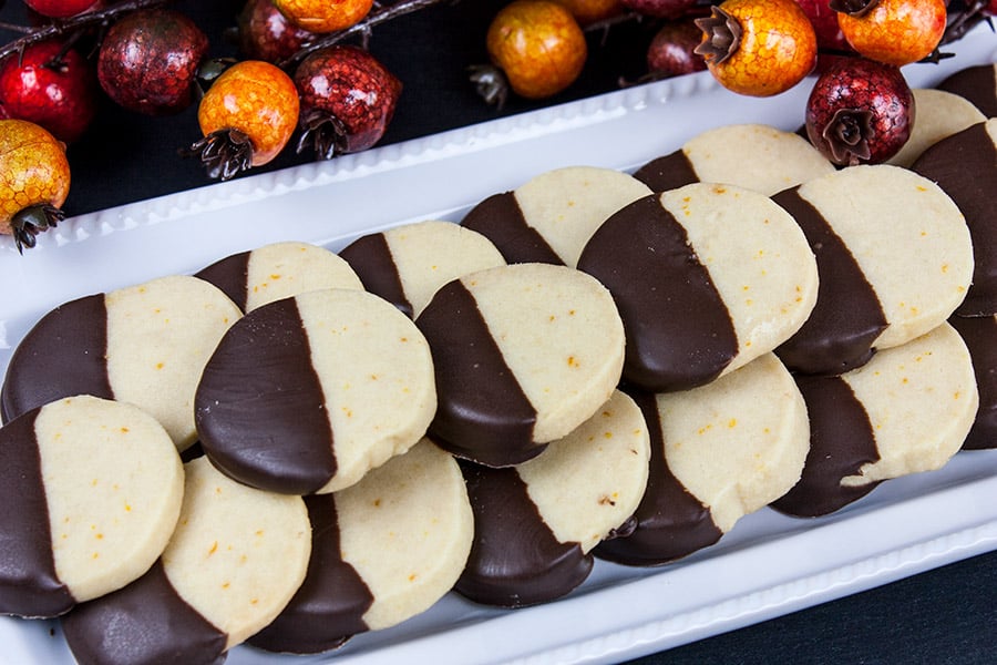 Chocolate Orange Shortbread Cookies stacked on a white platter.