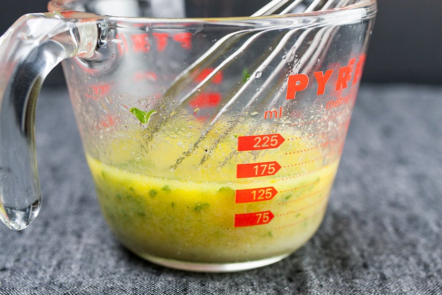 Pan-Seared Salmon Salad - Lemon Dijon Vinaigrette in a glass measuring cup
