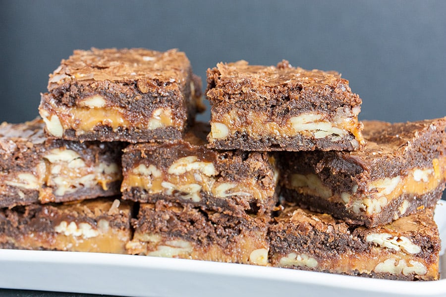 Ultimate Turtle Brownies stacked on white platter