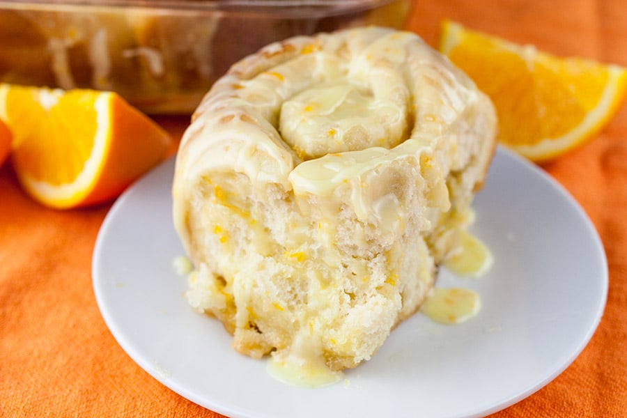An orange roll on a white plate.