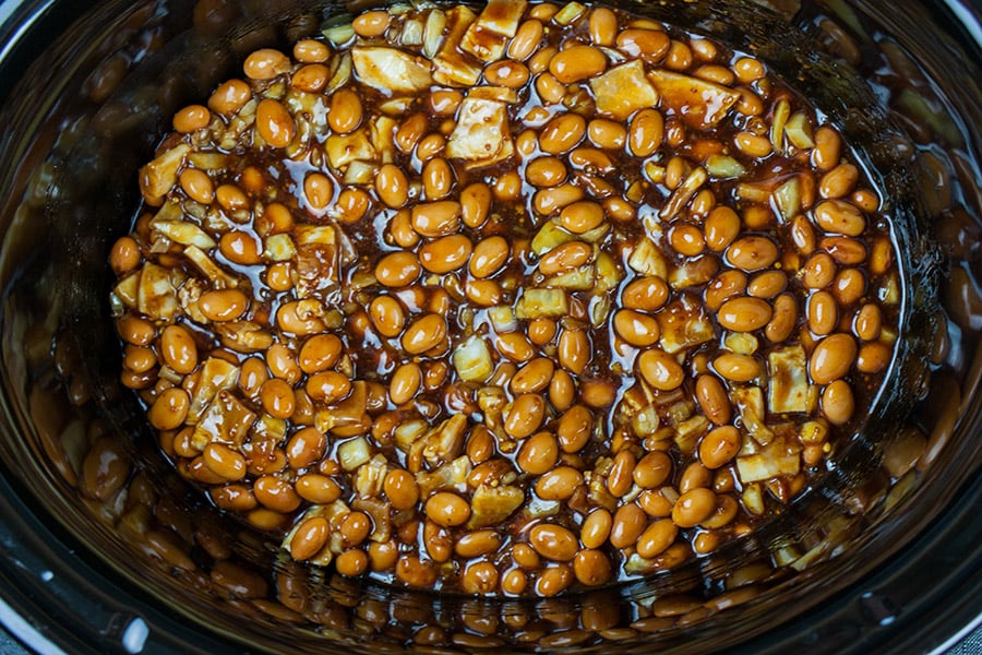 Boston baked beans in the slow cooker mixed with all the other ingredients.