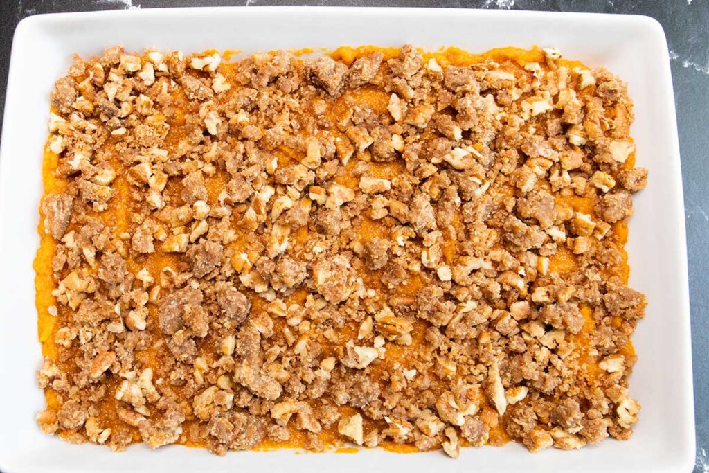 Unbaked casserole in a white baking pan.