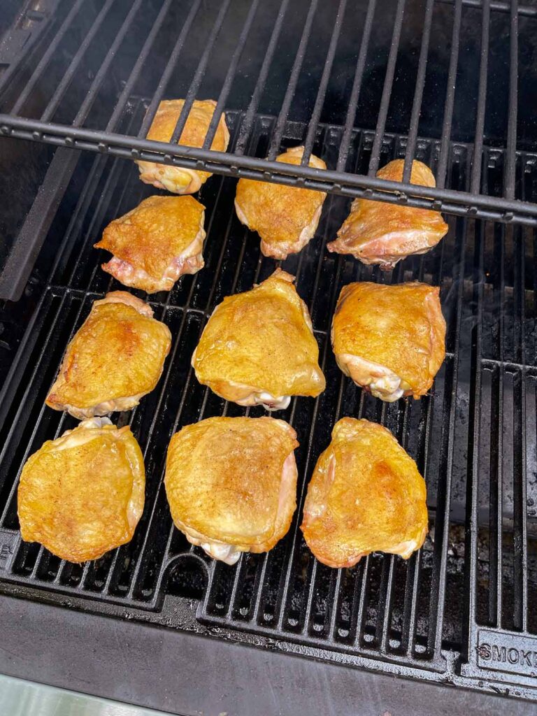 Chicken thighs with crispy skin on the smoker.
