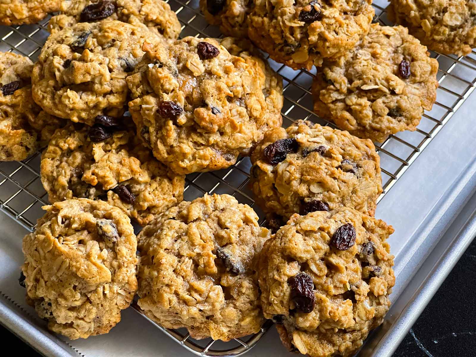 Old fashioned oatmeal cookies stacked on a wire rack.