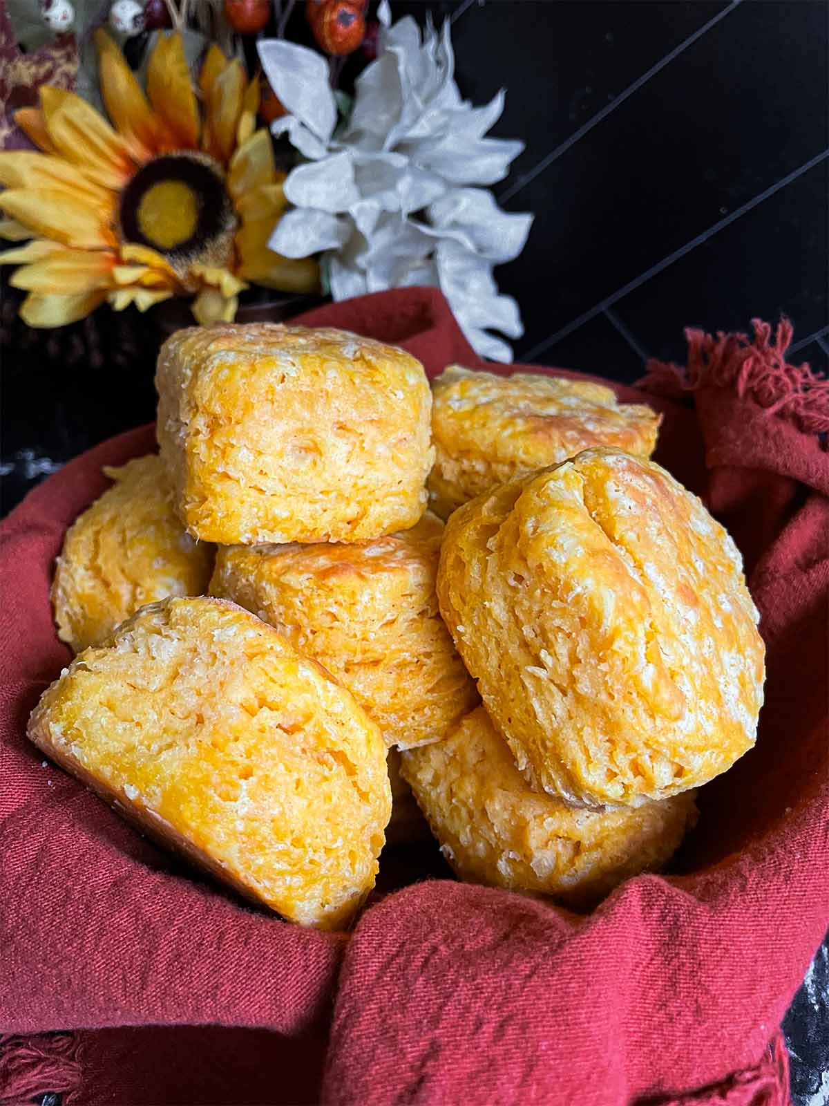 Sweet potato biscuits stacked in a linen lined basket.