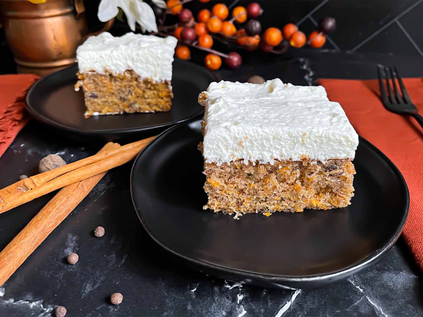 Serving of sweet potato cake on a dark plate.