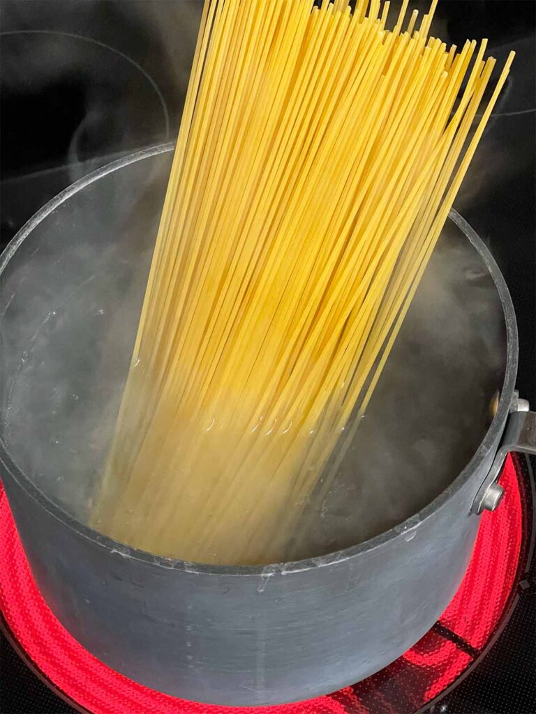 Spaghetti just added to boiling water.