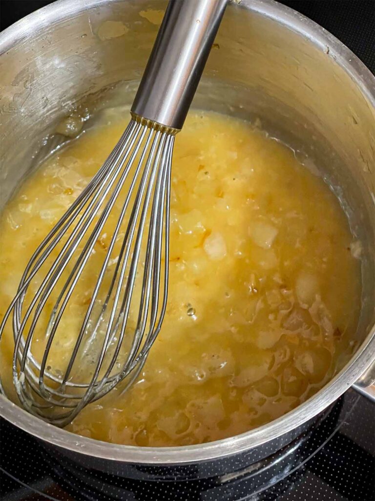 A roux cooking in a pot.