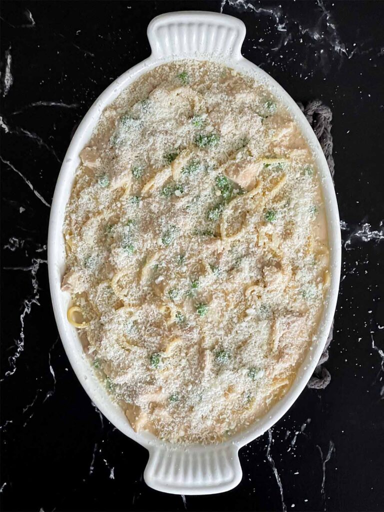 Chicken Tetrazzini covered in a cheese in a baking dish.