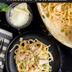 Chicken tetrazzini in a white baking dish with a serving on a dark plate.