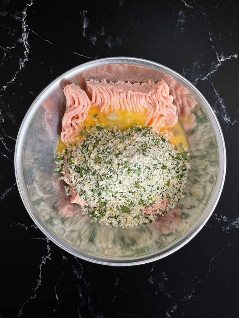 Chicken Piccata Meatballs mixture in a mixing bowl.