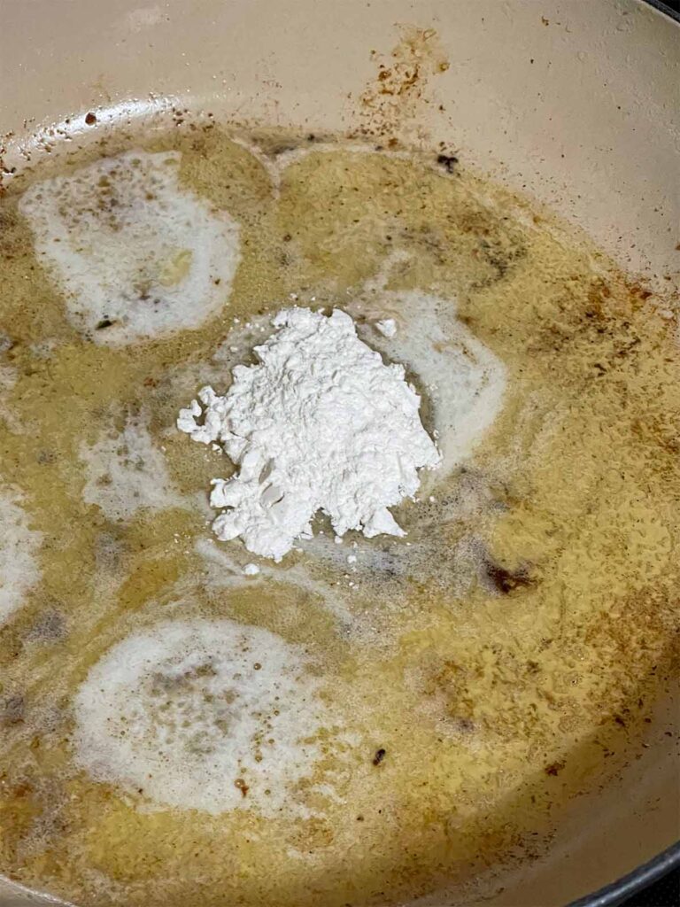 Melted butter, garlic, and flour in a skillet cooking.