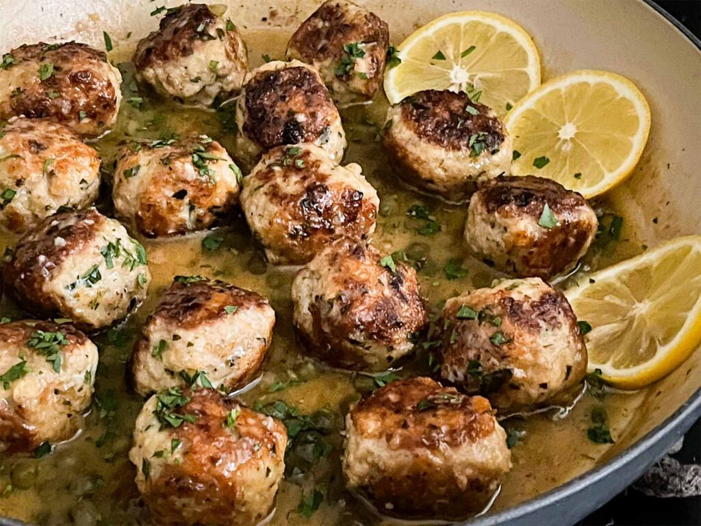 Chicken Piccata Meatballs in a skillet.