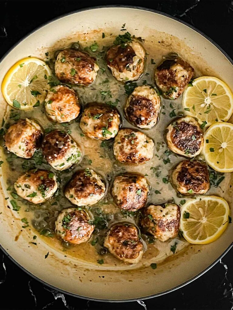 Chicken Piccata Meatballs in a skillet.