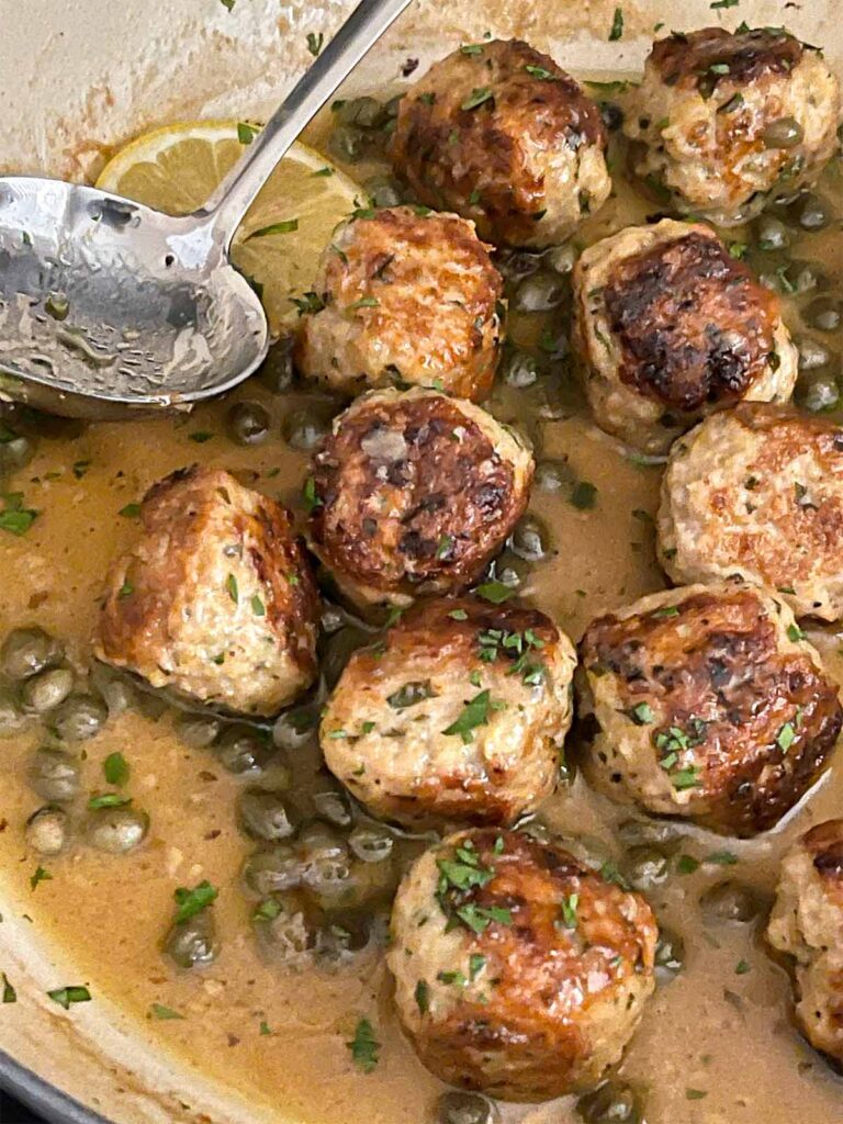 Chicken Piccata Meatballs in a skillet.