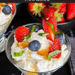 Ricotta mousse in a stemless martini glass garnished with strawberries, blueberries, basil, and honey.