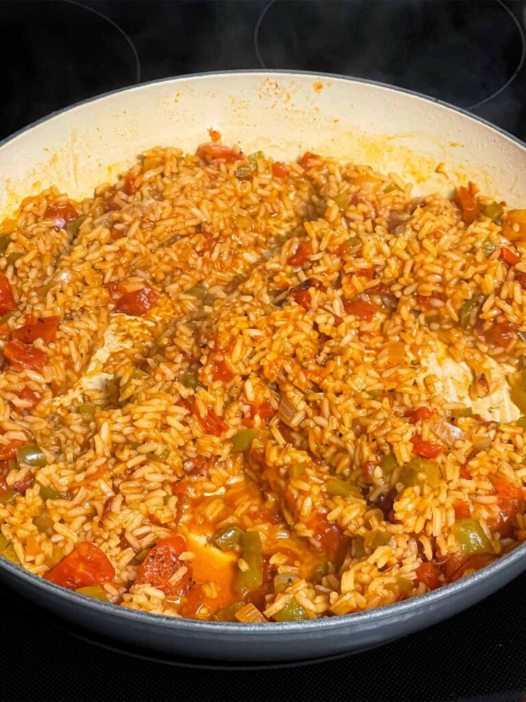 Cooked Spanish rice in a skillet.