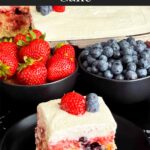 A slice of berry poke cake on a dark plate.