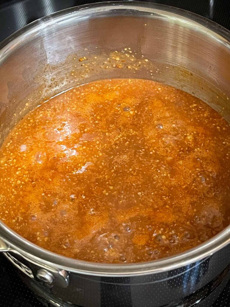 Barbecue sauce cooking in a sauce pan.