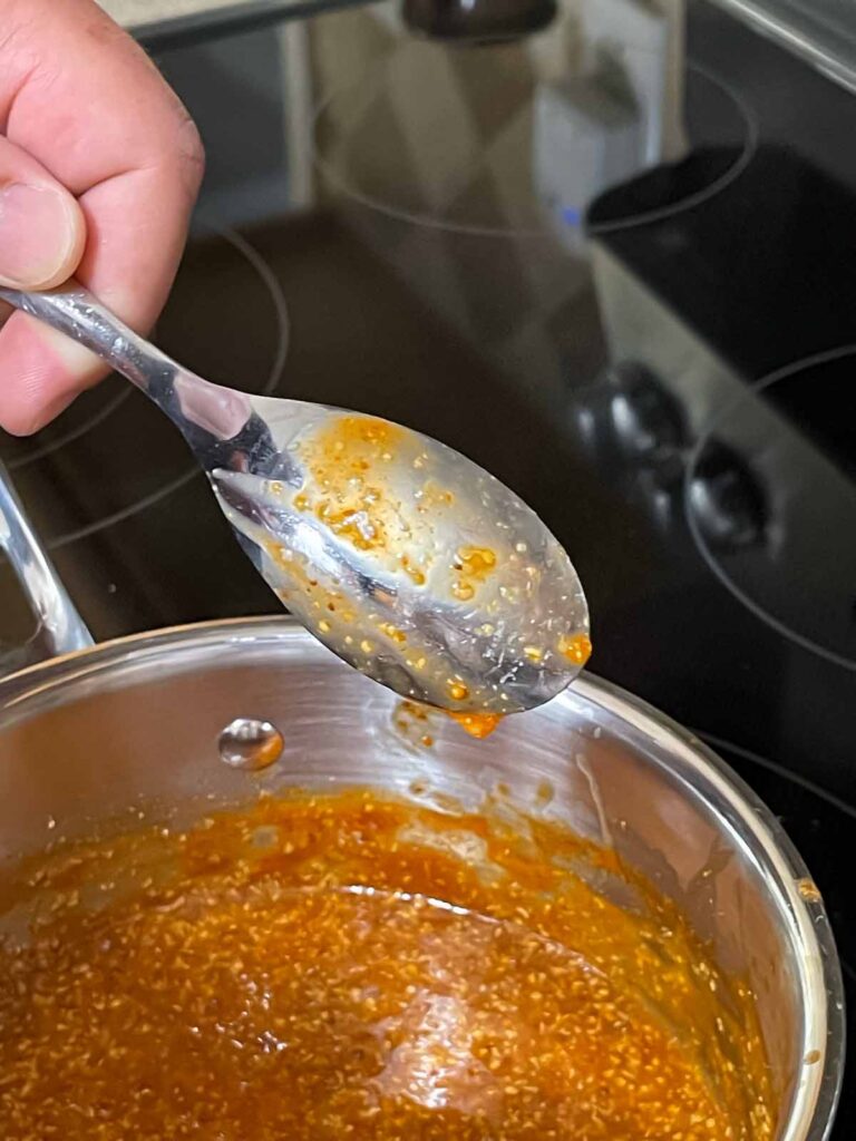 Showing the thickness of the sauce on the back of a spoon.