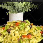 Mediterranean pasta salad mixed in a dark bowl.