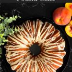 Peach pound cake on a dark plate on a dark surface.