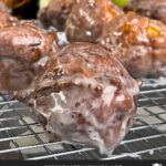 Apple fritters on a wire rack.