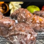 Apple fritters on a wire rack.