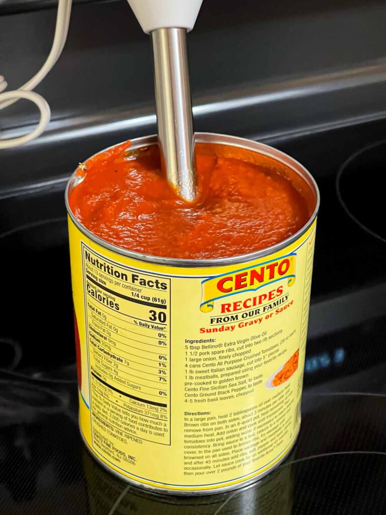 Blending crushed tomatoes in a can.