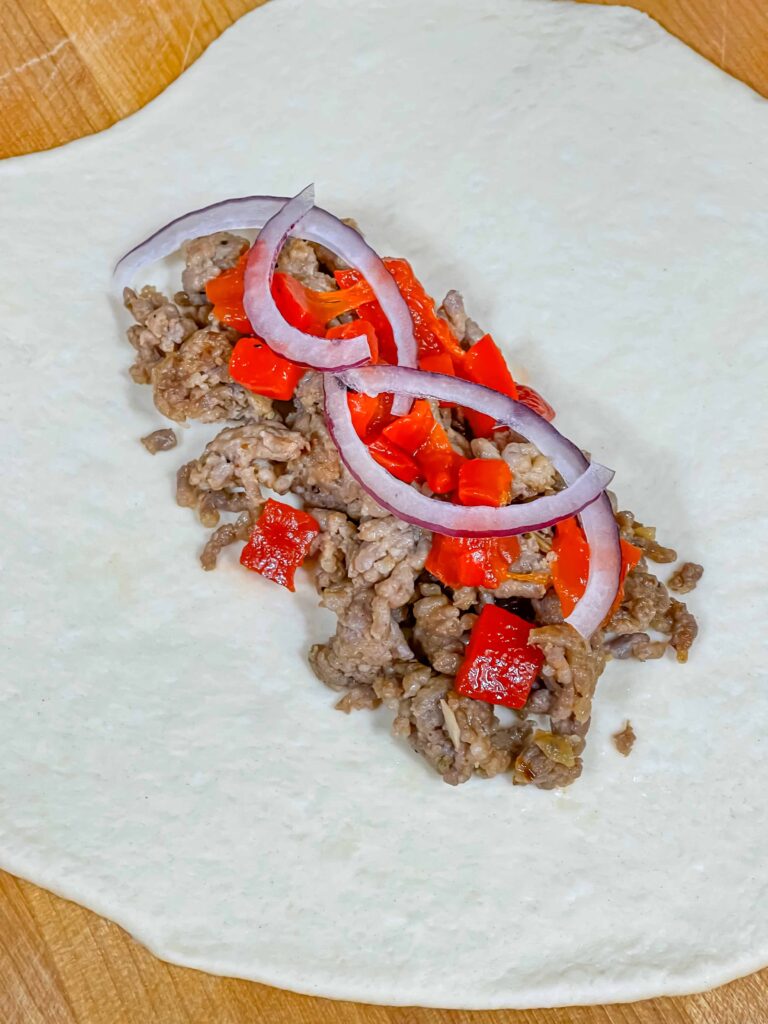 A calzone being assembled.