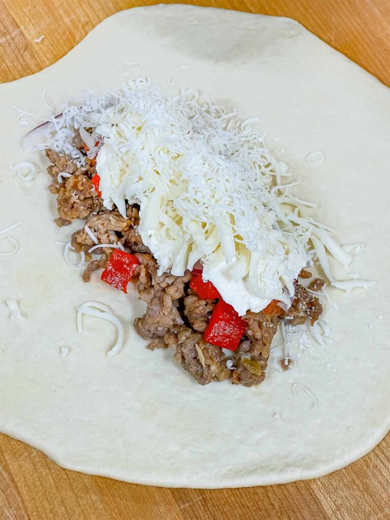 A calzone being assembled.