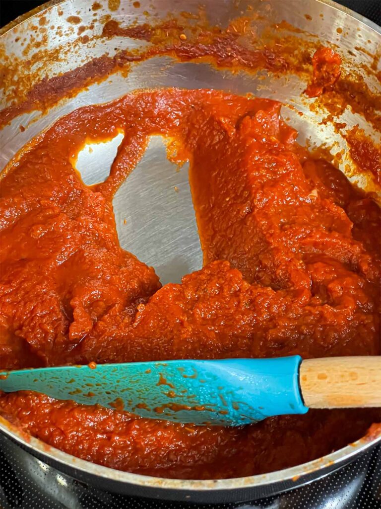 A dipping sauce for a calzone in a saucepan.