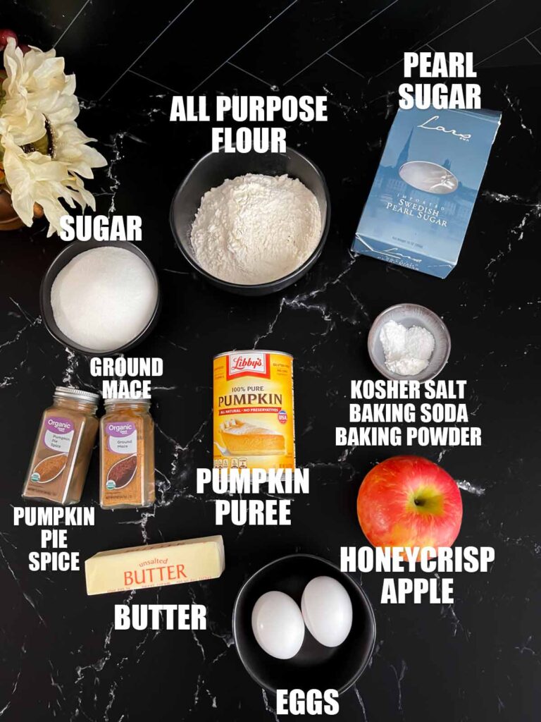 Pumpkin apple muffin recipe ingredients on a dark surface.