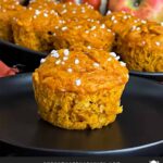 Pumpkin apple muffin on a dark plate.