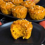 Pumpkin apple muffin on a dark plate.