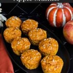 Pumpkin apple muffins on a dark oval platter.