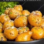 Slow cooker garlic parmesan potatoes in a dark bowl garnished with parsley and parmesan cheese.