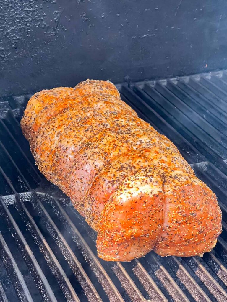 A pork loin on a smoker.