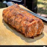 A Texas style smoked pork loin on cutting board.