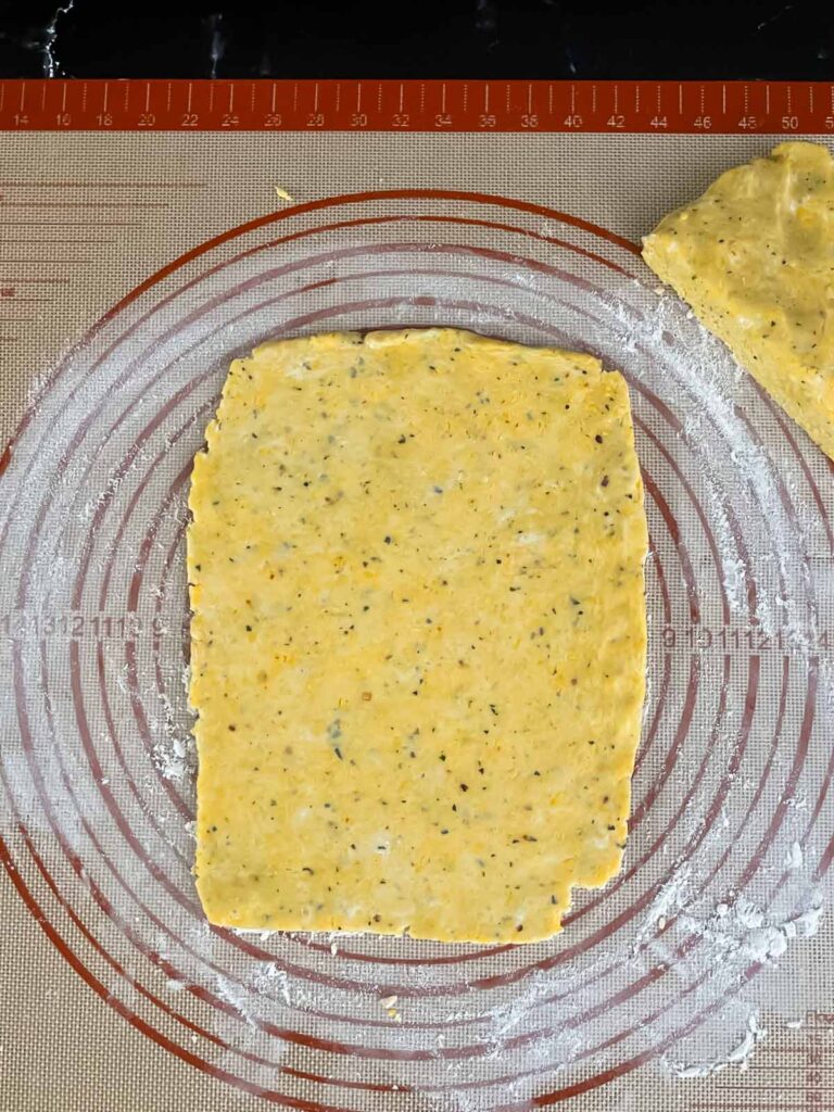 Cheese straw dough on a dough mat.