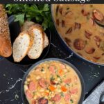 Bean soups with smoked sausage with bread and parsley in the background.