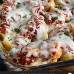 Italian sausage stuffed shells in a casserole dish.