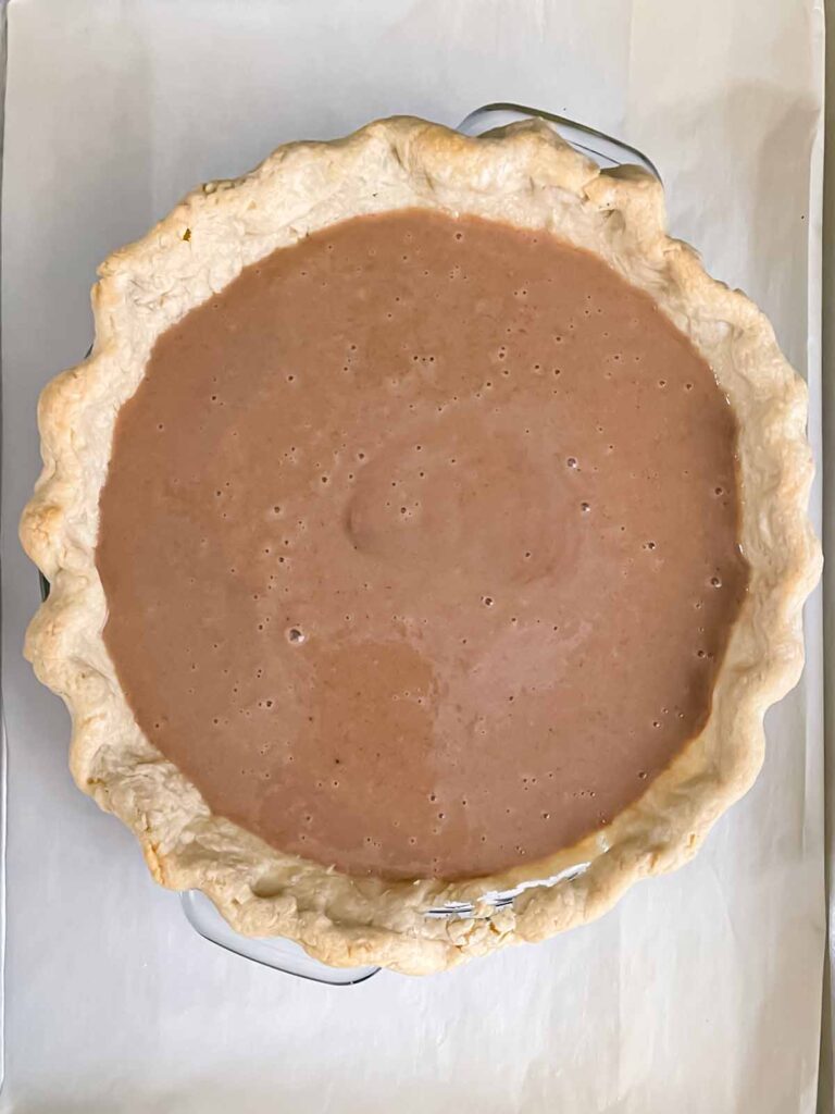 An apple butter pie, baked and a baking sheet.