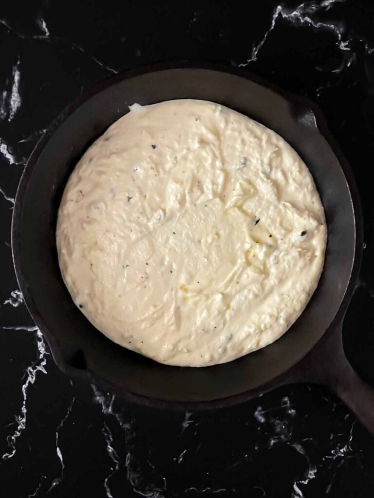 Ricotta dip in a cast iron skillet.