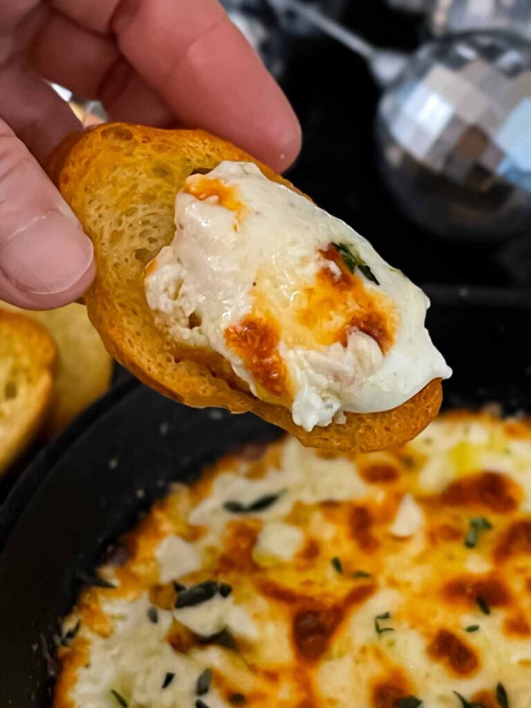 Baked Ricotta dip on a toasted baguette slice.