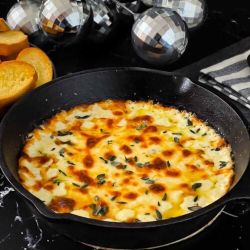 Baked Ricotta dip in a cast iron skillet.