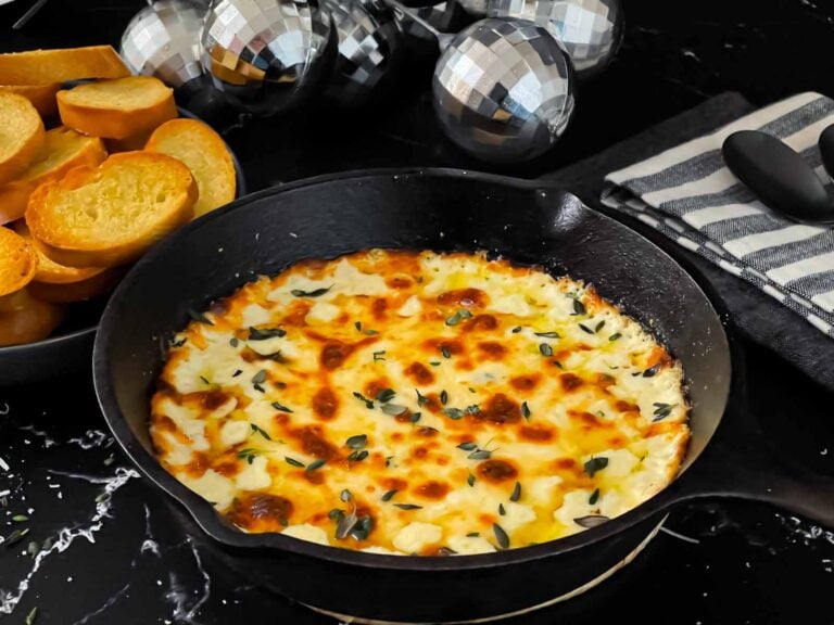 Baked Ricotta dip in a cast iron skillet.