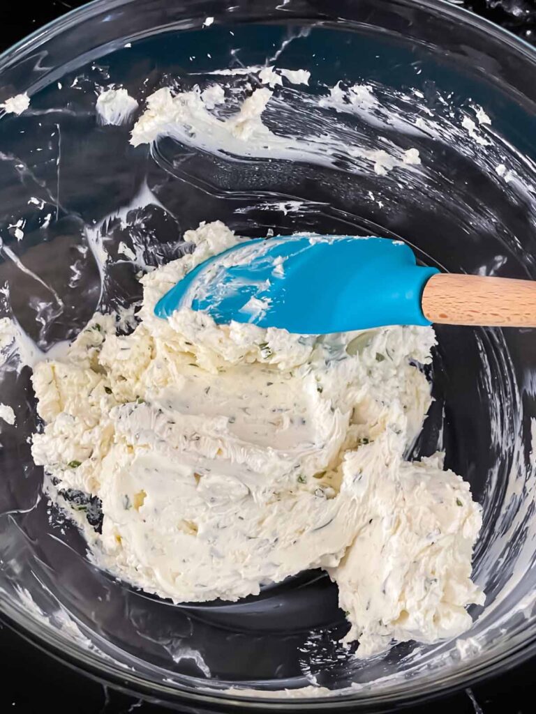 Ingredients for a cheese ball mixed in a bowl.